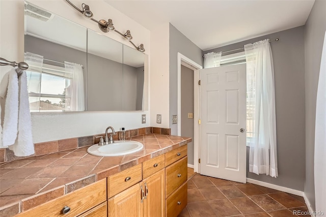 bathroom featuring tile patterned floors, visible vents, baseboards, and vanity