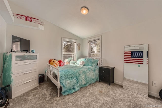 carpeted bedroom featuring lofted ceiling and baseboards