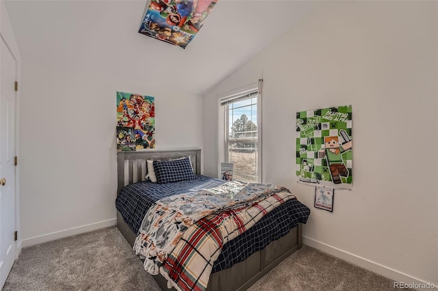 bedroom featuring lofted ceiling, baseboards, and carpet floors