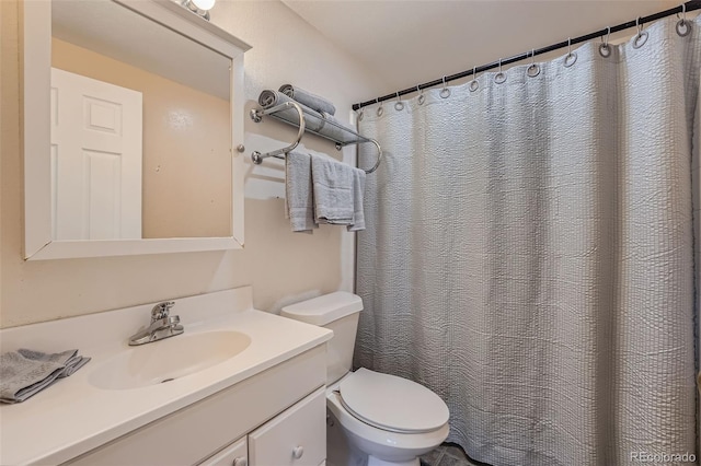 full bath featuring toilet and vanity