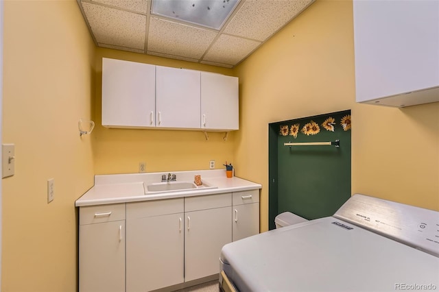 laundry area with washer / dryer, cabinet space, and a sink