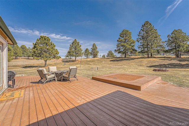 wooden terrace with a lawn