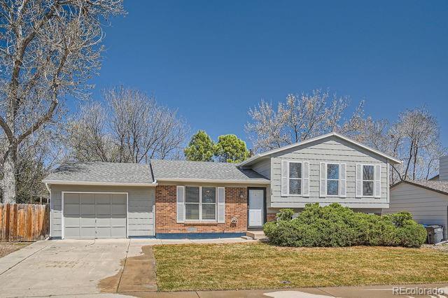 907 Stein St, Lafayette, CO 80026 - tri-level home with a garage, concrete driveway, and brick siding