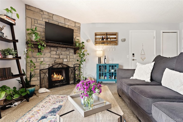 carpeted living area with a fireplace and a textured ceiling