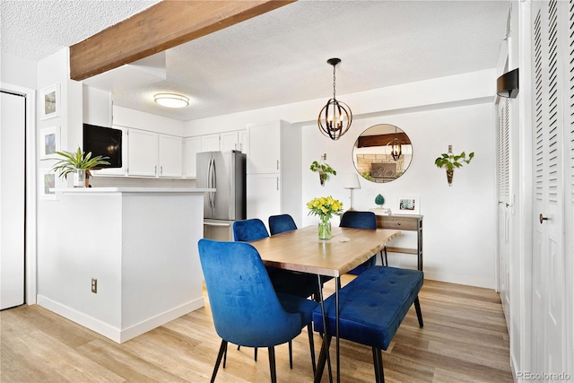 209 Wright St Unit 204, Lakewood, CO 80228 - dining area featuring beamed ceiling, a notable chandelier, light wood-type flooring, and a textured ceiling
