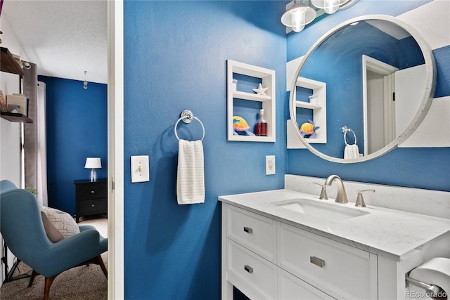 209 Wright St Unit 204, Lakewood, CO 80228 - bathroom with vanity, built in features, a textured wall, and a textured ceiling