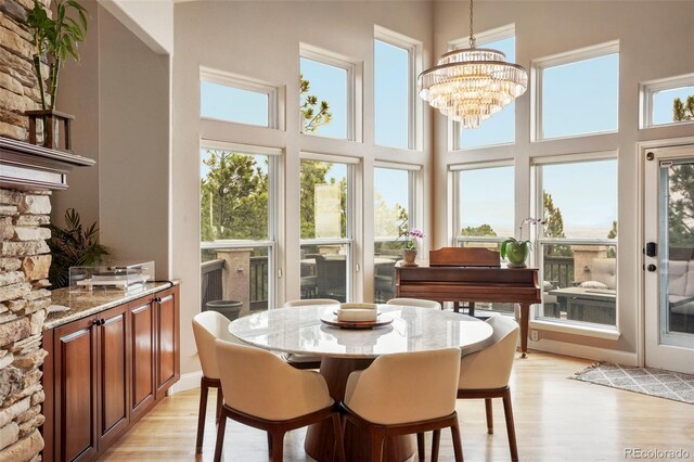 sunroom with a notable chandelier and plenty of natural light