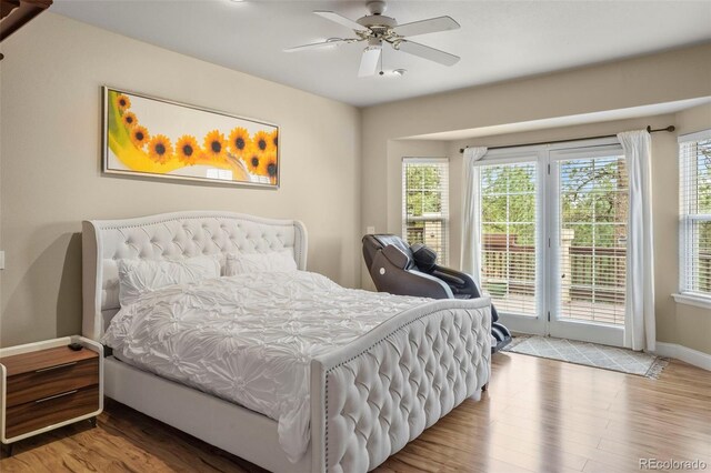 bedroom featuring hardwood / wood-style floors, access to exterior, and ceiling fan