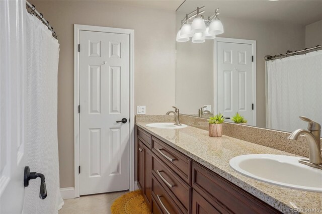 bathroom featuring vanity, a chandelier, and tile patterned flooring