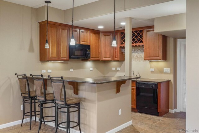 kitchen with a kitchen breakfast bar, black appliances, hanging light fixtures, and kitchen peninsula