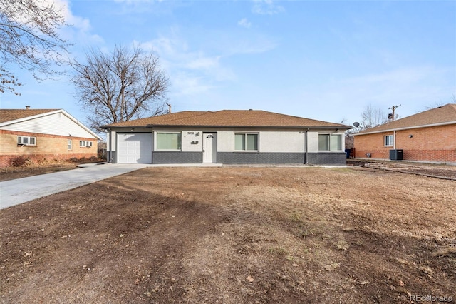 single story home with a garage and central air condition unit