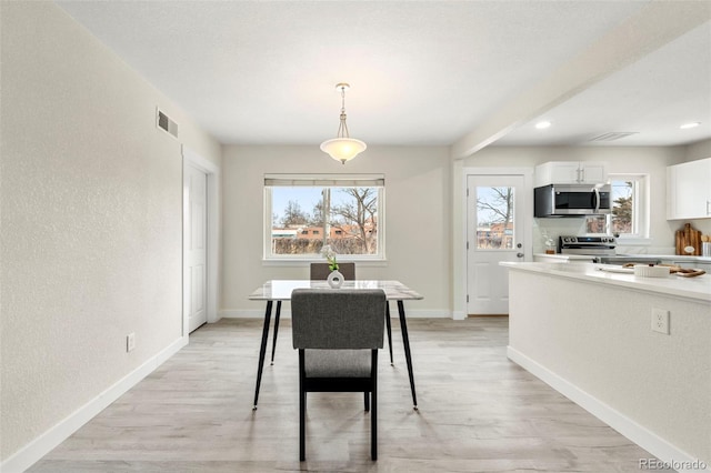 dining area featuring light wood-type flooring