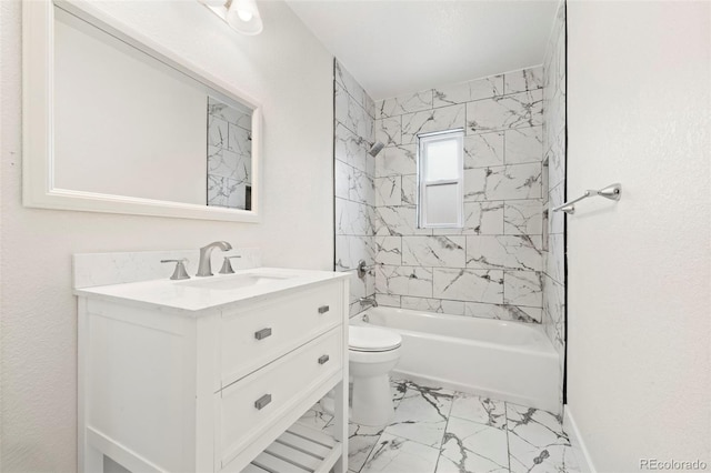 full bathroom featuring vanity, toilet, and tiled shower / bath