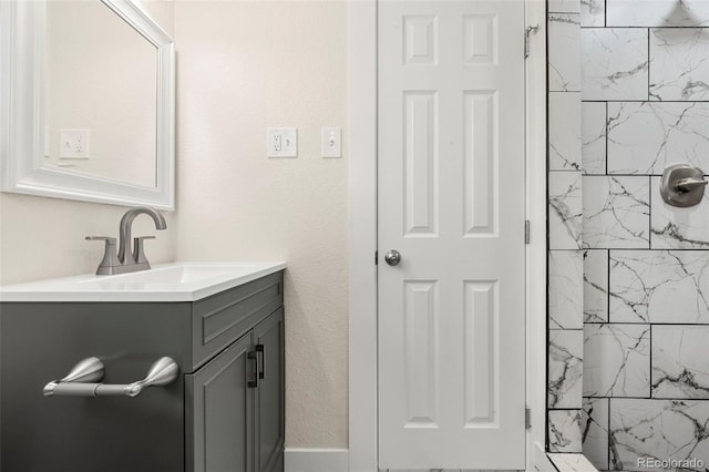 bathroom featuring vanity and tiled shower