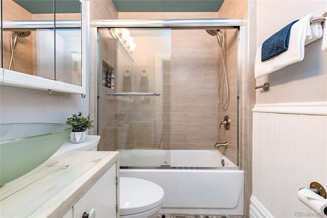 full bathroom with vanity, toilet, and combined bath / shower with glass door