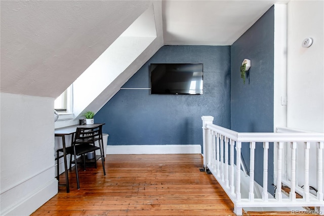 bonus room featuring lofted ceiling and hardwood / wood-style flooring