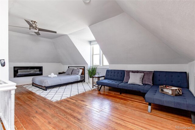 bedroom featuring wood-type flooring, vaulted ceiling, and ceiling fan