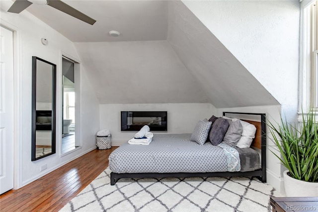 bedroom featuring vaulted ceiling, ceiling fan, and hardwood / wood-style flooring