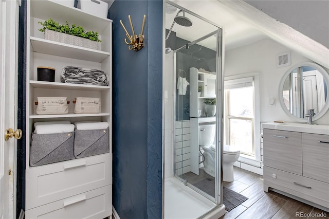 bathroom with walk in shower, vanity, toilet, and hardwood / wood-style flooring