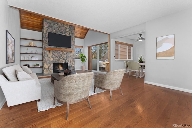 living room with a fireplace, wood-type flooring, lofted ceiling, and wood ceiling