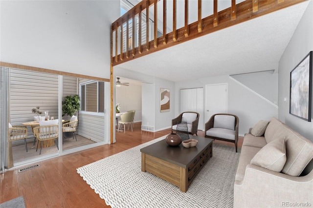 living room with ceiling fan and wood-type flooring