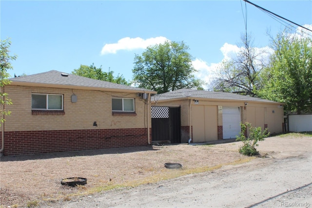 exterior space with brick siding and an outdoor structure