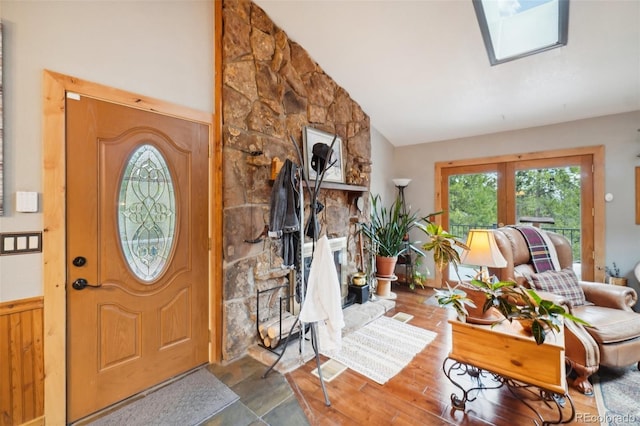 entrance foyer featuring french doors, lofted ceiling with skylight, and hardwood / wood-style floors