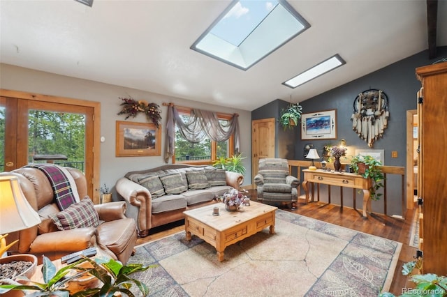 living room with plenty of natural light, lofted ceiling with skylight, and light wood-type flooring