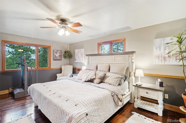 bedroom with ceiling fan and dark hardwood / wood-style floors