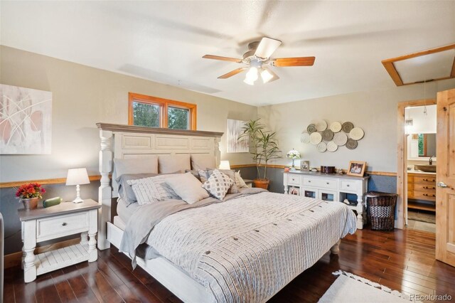 bedroom featuring ceiling fan, connected bathroom, and dark hardwood / wood-style flooring