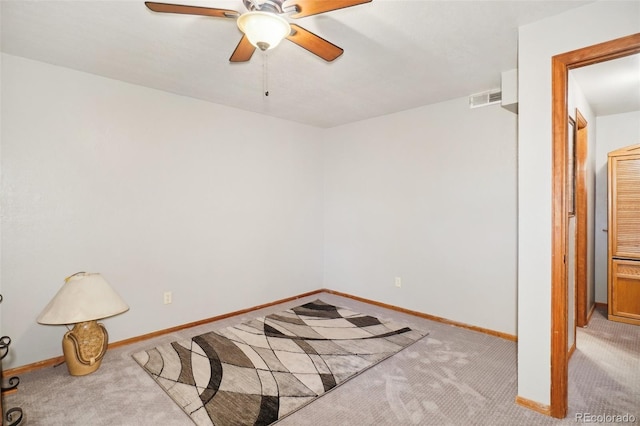 empty room with ceiling fan and light colored carpet