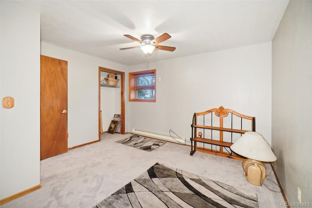 interior space with light carpet, ceiling fan, and baseboard heating