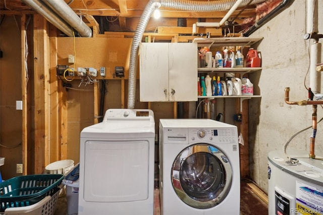 washroom featuring electric water heater and independent washer and dryer