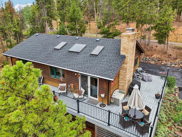 back of house featuring a deck and french doors