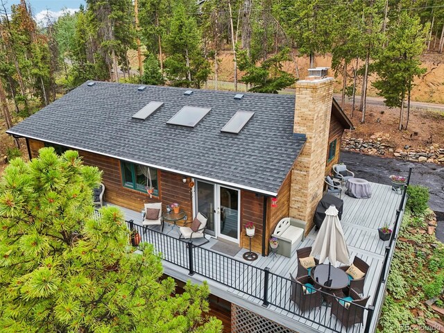 back of house featuring a deck and french doors