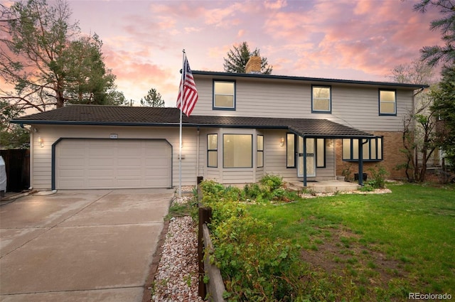 930 S Dayton St, Denver, CO 80247 - traditional home featuring an attached garage, concrete driveway, a front yard, and a chimney