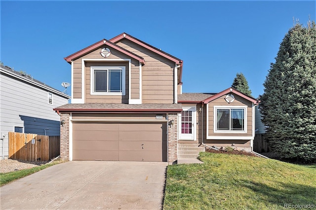 view of front of home with a front yard and a garage