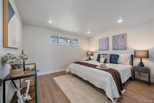 bedroom with wood-type flooring