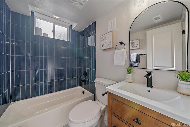 full bathroom featuring tiled shower / bath combo, vanity, and toilet