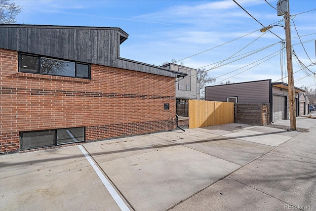 view of home's exterior with a garage and an outdoor structure