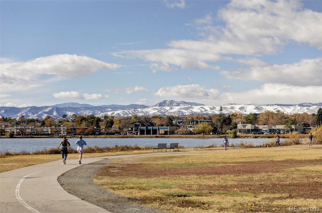 view of home's community with a yard and a water and mountain view