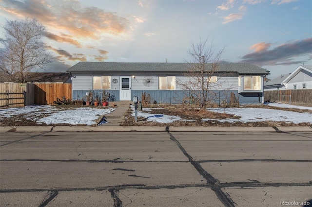 view of front of home featuring fence