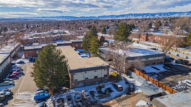 snowy aerial view with a mountain view