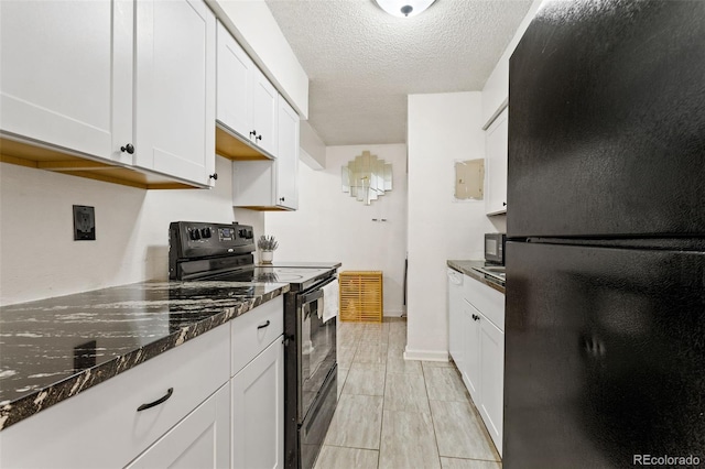 kitchen with dark stone countertops, white cabinetry, black appliances, and a textured ceiling