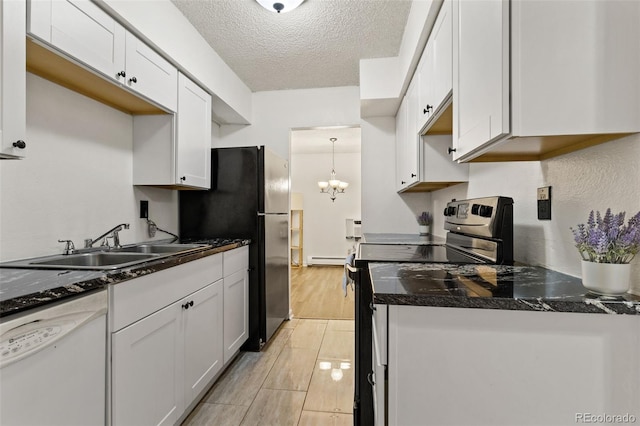 kitchen featuring white dishwasher, sink, stainless steel electric range oven, a textured ceiling, and white cabinetry