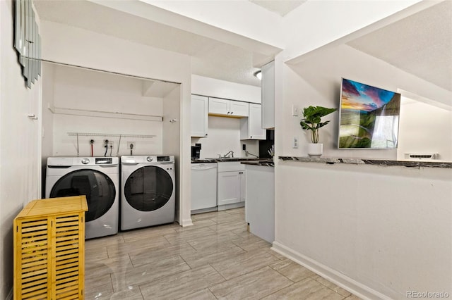 washroom featuring washer and clothes dryer and sink