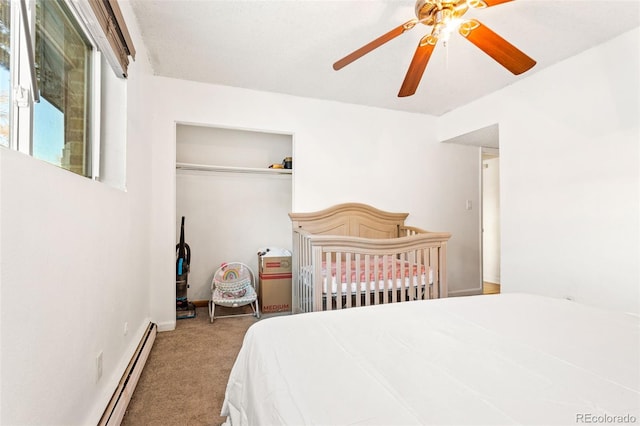 bedroom featuring carpet flooring, a closet, ceiling fan, and a baseboard heating unit