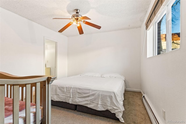 bedroom with carpet, ceiling fan, a textured ceiling, and a baseboard heating unit