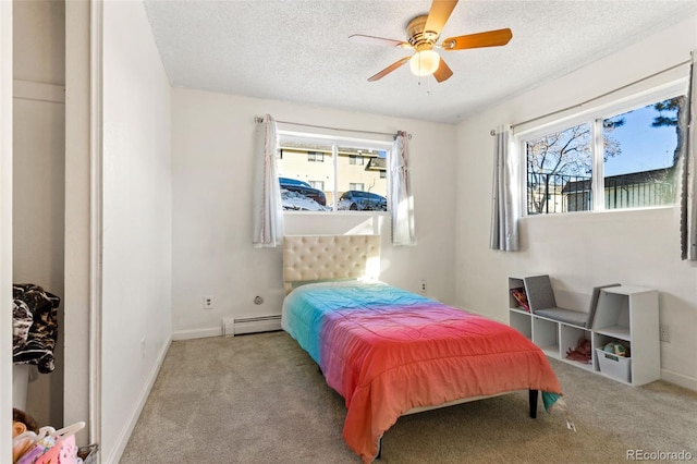 bedroom featuring baseboard heating, ceiling fan, light colored carpet, and a textured ceiling