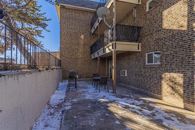 view of property exterior featuring a patio and a balcony